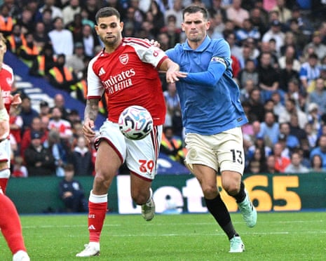 Arsenal's Bruno Guimaraes battles Brighton's Pascal Gross for the ball