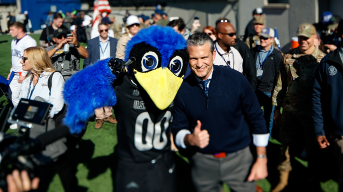 Pete Hegseth realiza o sorteio de moeda entre a Força Aérea e a Marinha após demonstrar suas habilidades de basquete na Academia