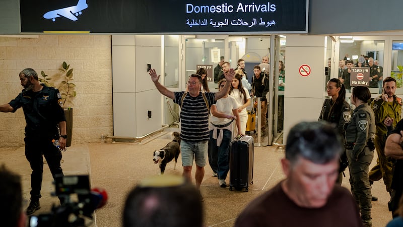 A passenger exits through the domestic arrivals doors with his dog and his luggage at Ben Gurion Airport. Getty Images