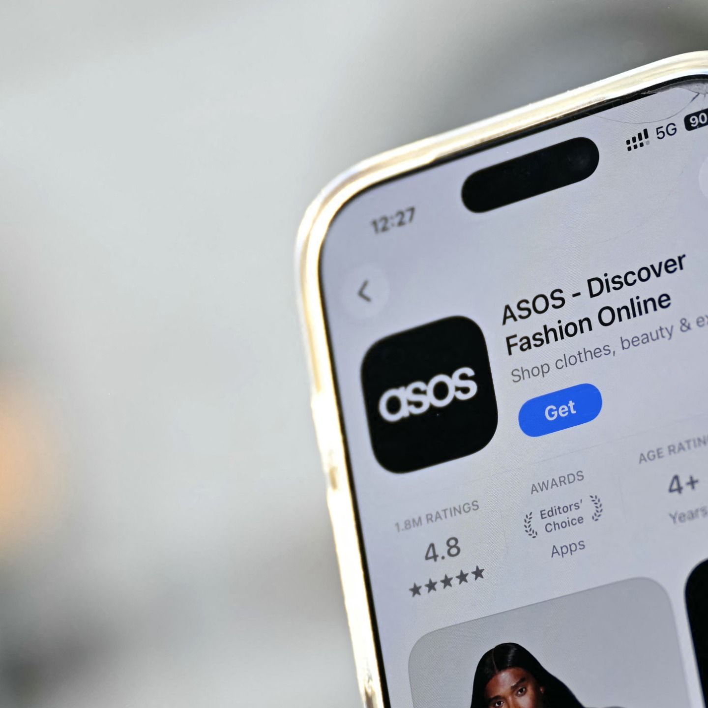 A phone showing the ASOS app download page